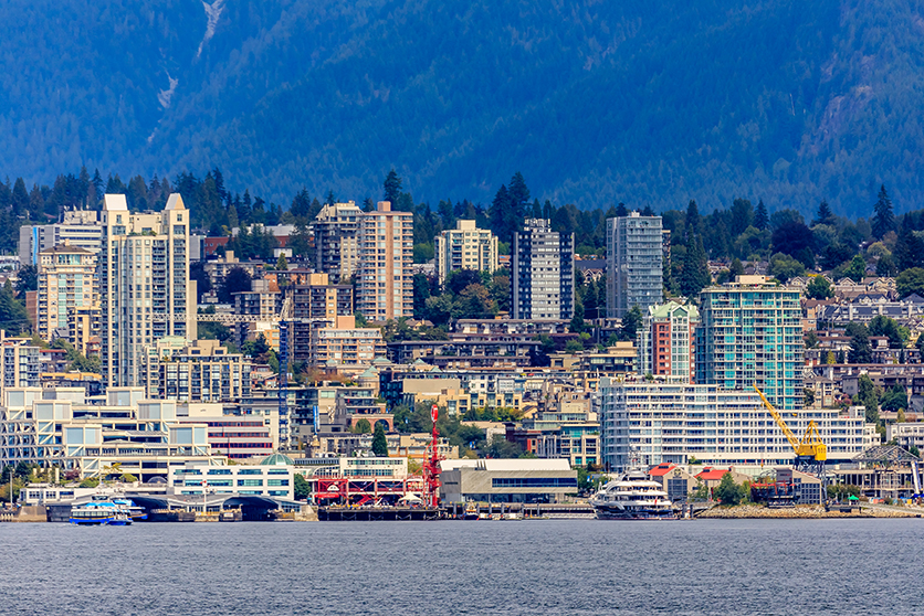 Vancouver North Shore skyline and waterfront cityscape with Grouse mountain on a cloudy day in British Columbia, Canada