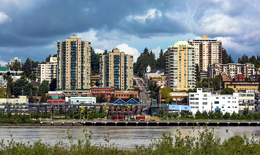New Westminster British Columbia, The Center of City at the Waterfront of Fraser River. Promenade, multi-level parking lot, historic building, among the new high-rise buildings